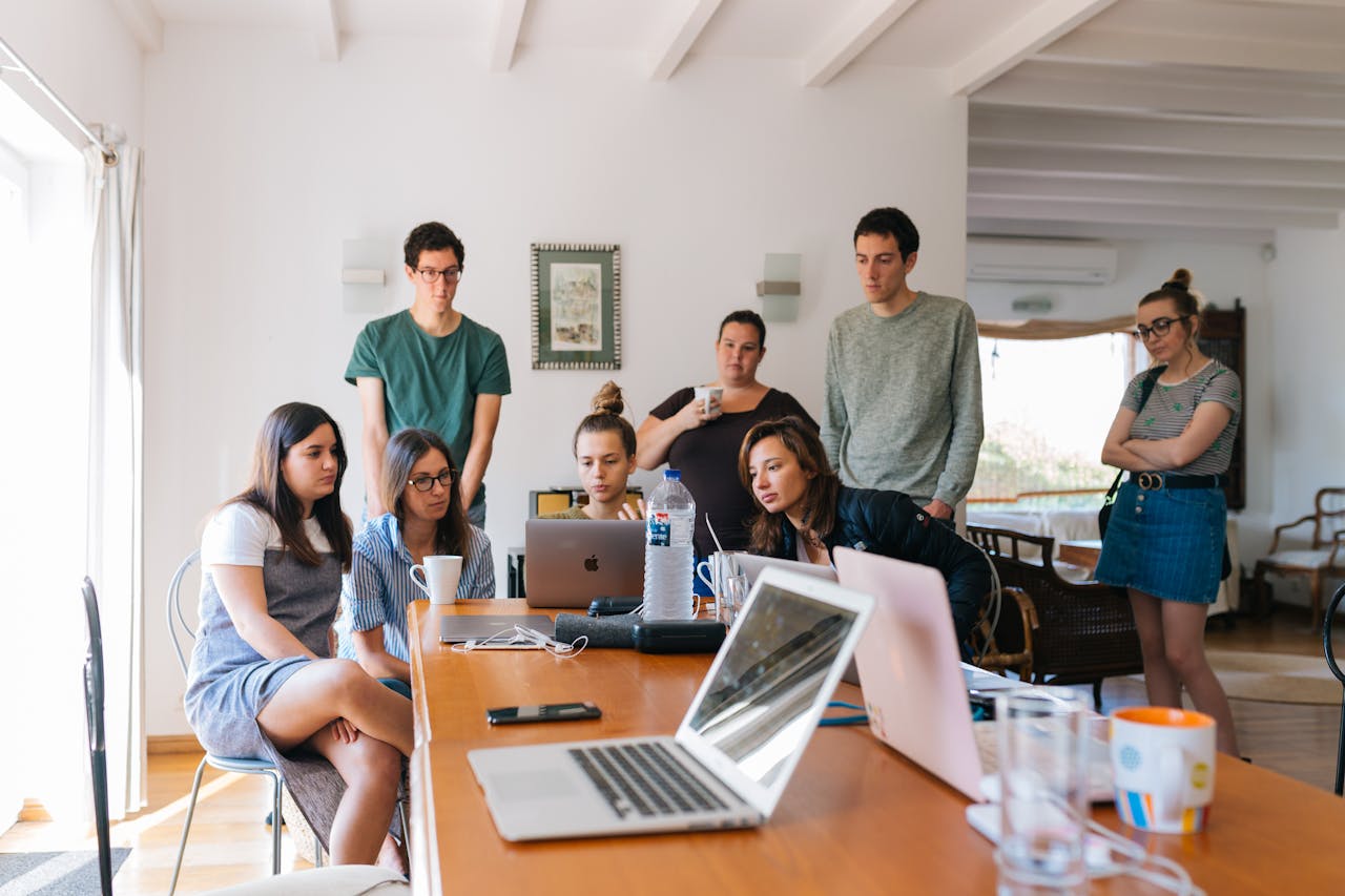 About Group of young professionals engaged in a collaborative meeting in a modern office setting.